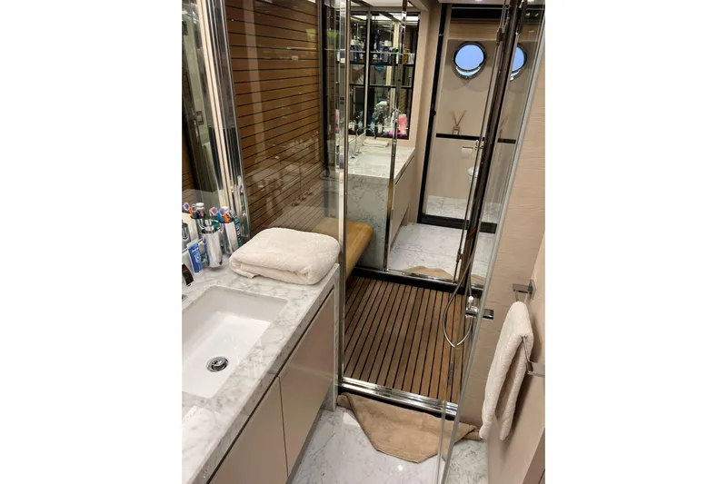  Yacht Photos Pics Luxurious bathroom interior of 2015 Azimut 80 yacht with marble sink and wooden flooring.