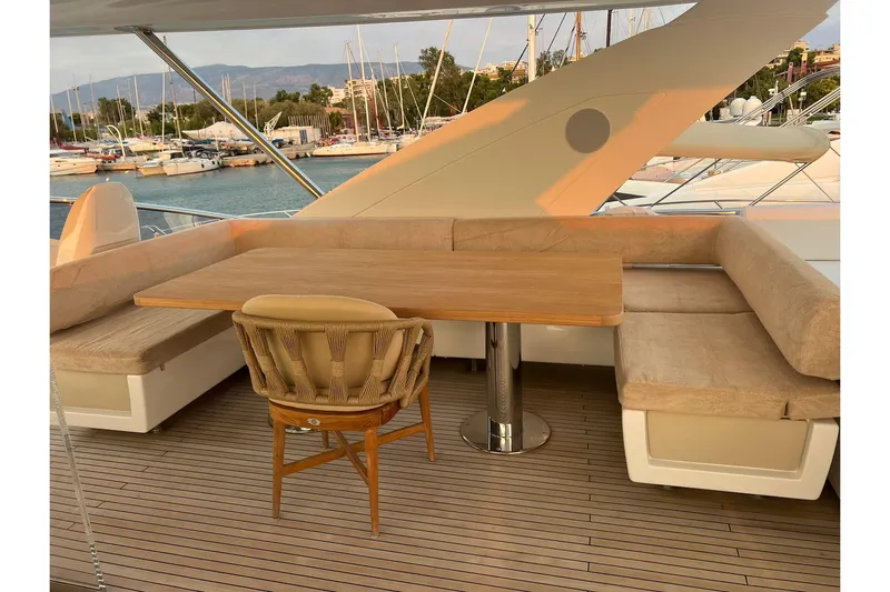  Yacht Photos Pics Luxurious seating area on 2015 Azimut 80 yacht with wooden table and cushioned benches.
