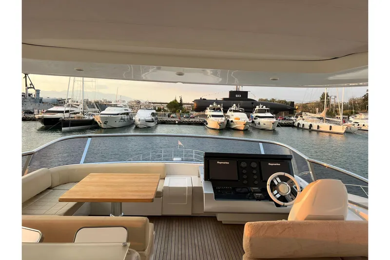  Yacht Photos Pics Luxurious 2015 Azimut 80 yacht interior with marina view, featuring helm and seating area.