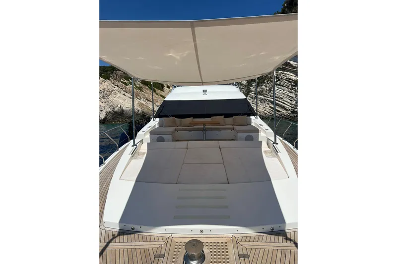  Yacht Photos Pics Luxurious 2015 Azimut 80 yacht deck with sunshade, featuring elegant seating and scenic coastal backdrop.