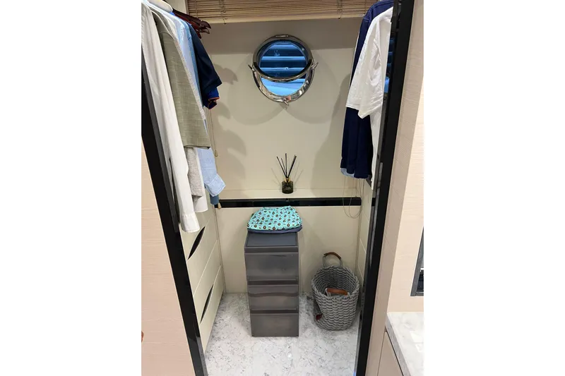  Yacht Photos Pics Luxurious Azimut 80 yacht closet with clothes, drawers, and porthole, 2015 model.