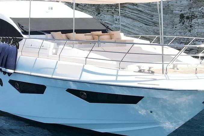  Yacht Photos Pics Luxurious 2015 Azimut 80 yacht with sleek design, docked near rocky shoreline.