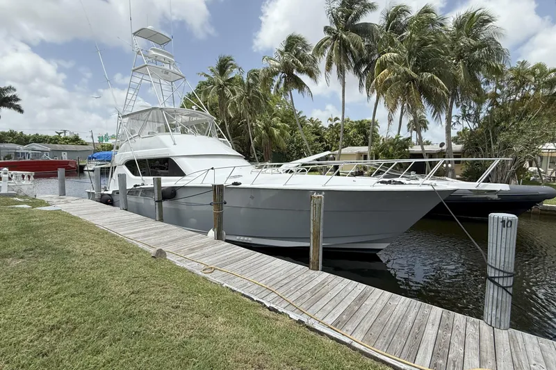 Sunday Gravy Too Yacht Photos Pics 2000 Hatteras 60 Convertible yacht docked by palm trees.