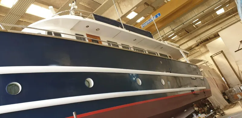  Yacht Photos Pics Cantieri Nord Est Navalmeccanica Navetta 2005 yacht in a shipyard, side view.