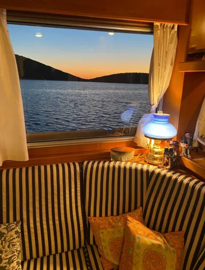  Yacht Photos Pics Interior of 2005 Cantieri Nord Est yacht with sea view at sunset through window.