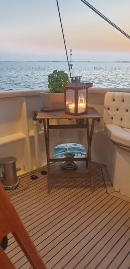  Yacht Photos Pics Cozy yacht deck with lantern, sea view; Cantieri Nord Est Navalmeccanica Navetta, 2005.