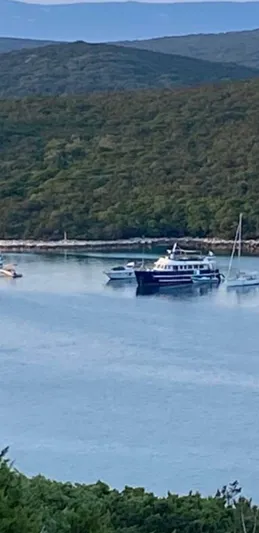  Yacht Photos Pics A 2005 Cantieri Nord Est Navalmeccanica Navetta yacht anchored in a serene bay.