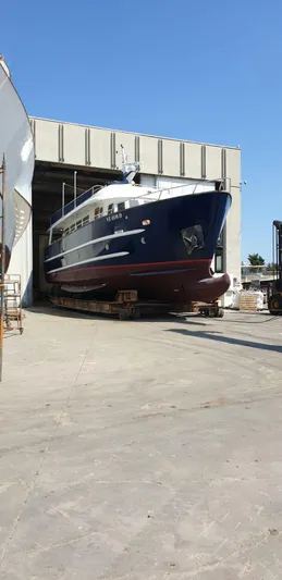  Yacht Photos Pics Cantieri Nord Est Navalmeccanica Navetta 2005 yacht in shipyard, partially inside a large hangar.