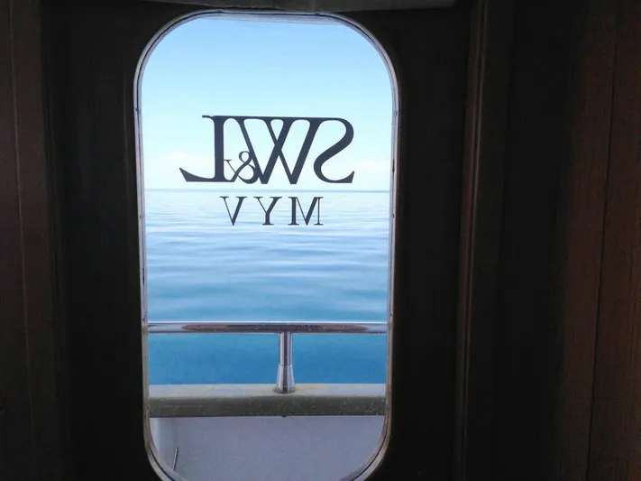  Yacht Photos Pics Porthole view from 2005 Cantieri Nord Est Navalmeccanica Navetta, overlooking calm sea.