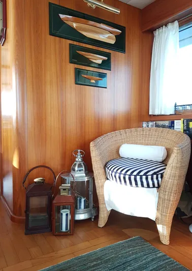  Yacht Photos Pics Cozy yacht interior with wicker chair, nautical decor, and wooden paneling, Cantieri Nord Est Navalmeccanica Navetta 2005.