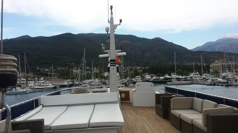  Yacht Photos Pics Luxurious 2005 Cantieri Nord Est yacht docked in scenic marina with mountain backdrop.