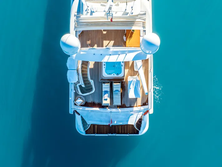  Yacht Photos Pics Aerial view of 2013 Azimut 105 yacht with deck and jacuzzi on blue water.