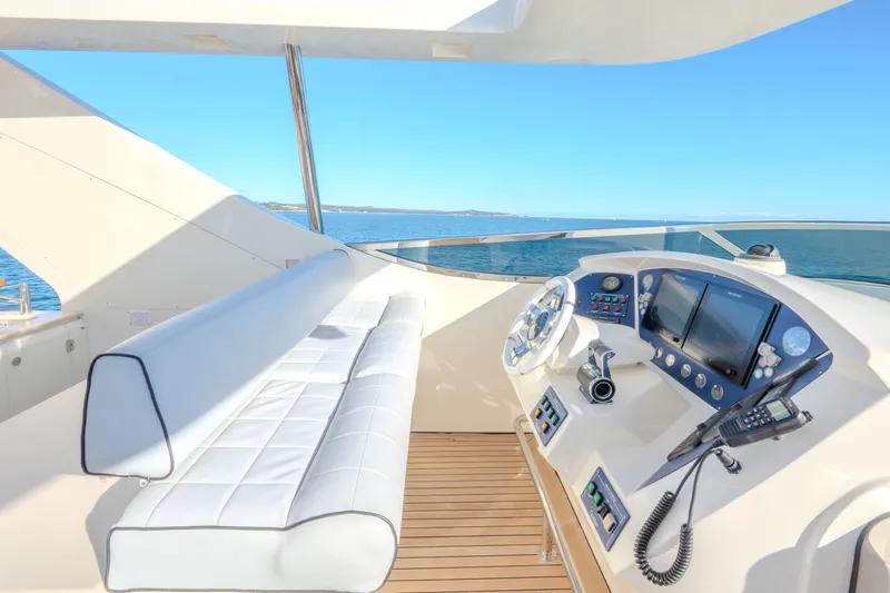  Yacht Photos Pics Luxurious 2013 Azimut 105 yacht helm with white seating and modern navigation equipment.