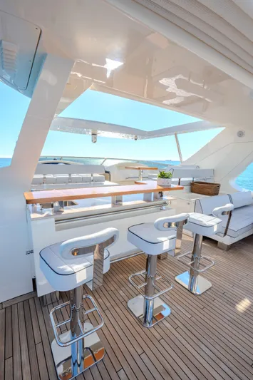  Yacht Photos Pics Luxurious 2013 Azimut 105 yacht deck with bar stools and ocean view.