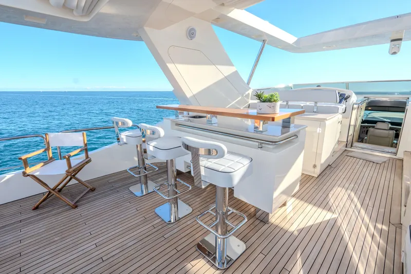  Yacht Photos Pics Luxurious 2013 Azimut 105 yacht deck with bar stools and ocean view.