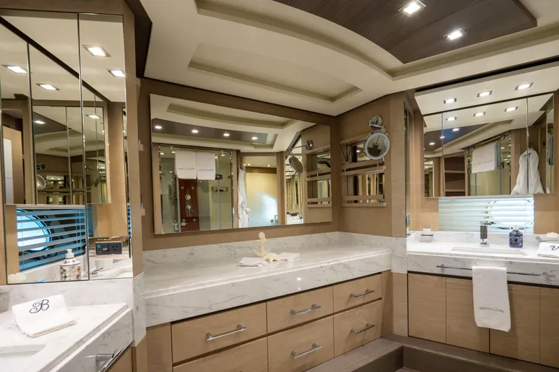  Yacht Photos Pics Luxurious bathroom interior on a 2013 Azimut 105 yacht, featuring elegant wood and marble finishes.
