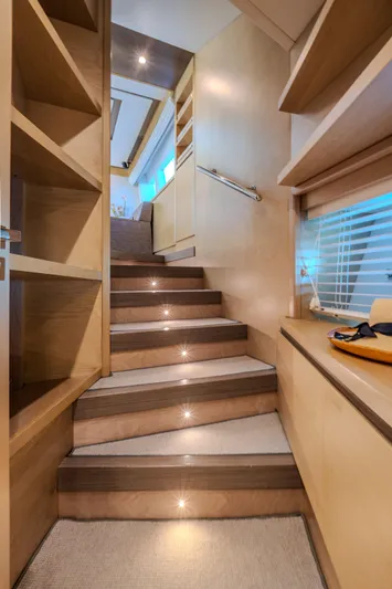  Yacht Photos Pics Interior staircase of 2013 Azimut 105 yacht with modern wooden design and ambient lighting.