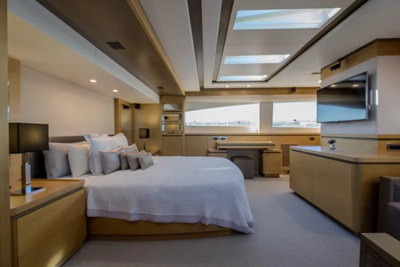 Yacht Photos Pics Luxurious bedroom interior of 2013 Azimut 105 yacht with modern furnishings and skylights.