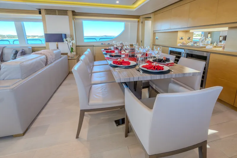  Yacht Photos Pics Luxurious dining area on a 2013 Azimut 105 yacht, elegantly set with red accents.