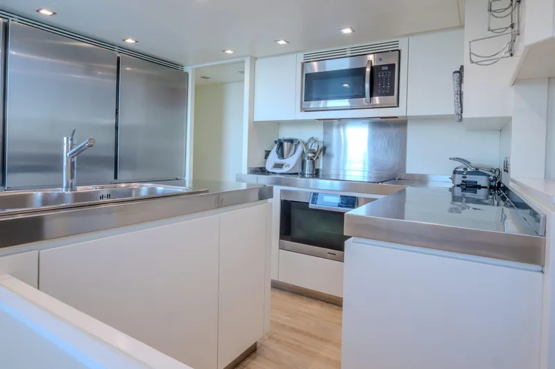  Yacht Photos Pics Modern kitchen in 2013 Azimut 105 yacht with stainless steel appliances and sleek design.