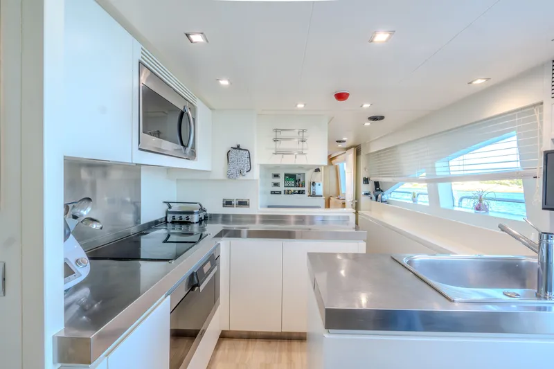  Yacht Photos Pics Modern kitchen interior on a 2013 Azimut 105 yacht, featuring sleek stainless steel appliances.