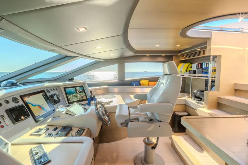  Yacht Photos Pics Luxurious Azimut 105 yacht cockpit interior, 2013 model, featuring modern navigation equipment and panoramic ocean views.