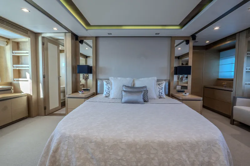  Yacht Photos Pics Luxurious bedroom interior on a 2013 Azimut 105 yacht, featuring elegant decor and modern amenities.