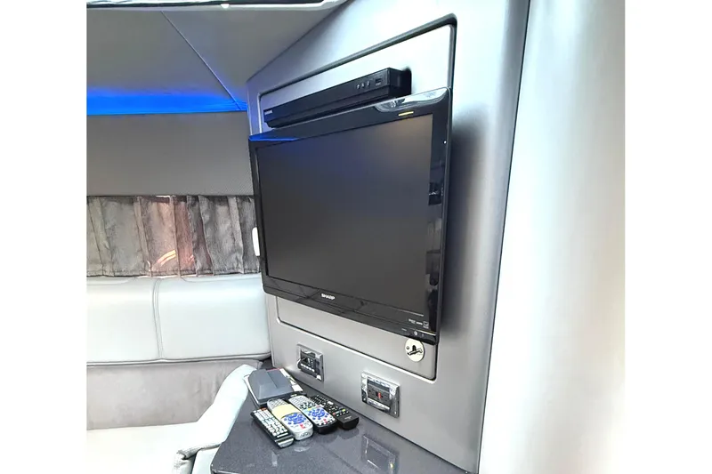  Yacht Photos Pics Interior of 2015 Formula 400 Super Sport with TV and remote controls on a counter.