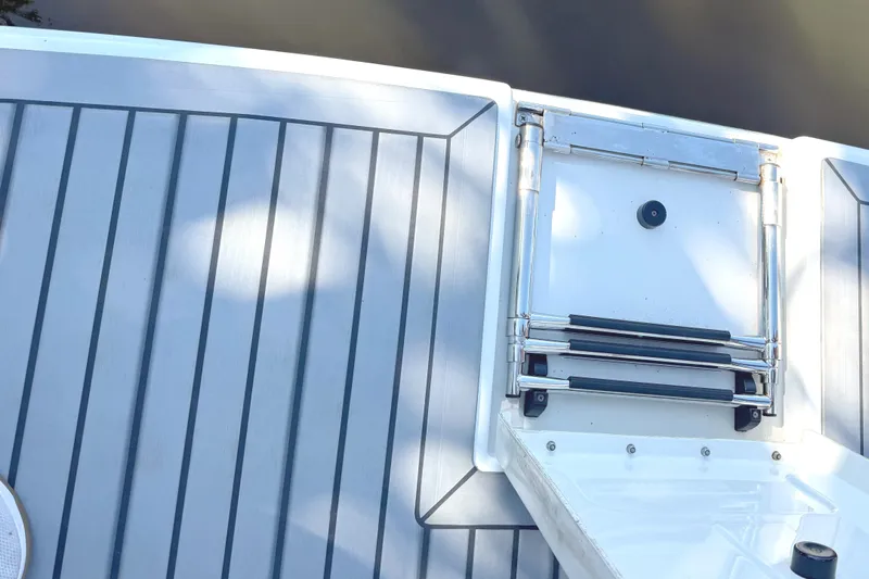  Yacht Photos Pics 2015 Formula 400 Super Sport boat deck with retractable ladder and person wearing sneakers.