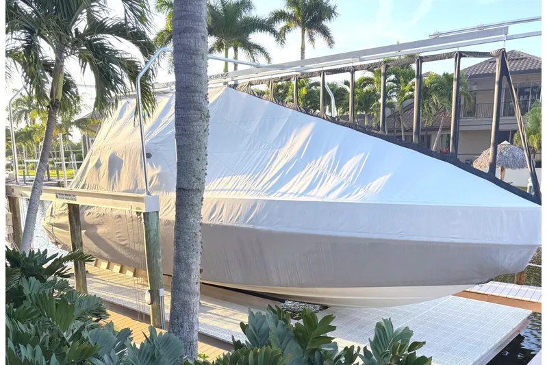  Yacht Photos Pics Covered 2015 Formula 400 Super Sport boat docked near tropical plants.