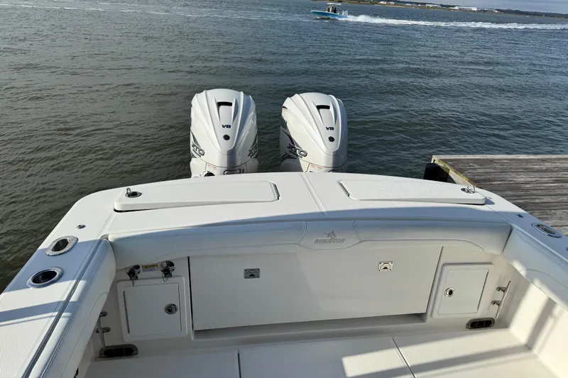  Yacht Photos Pics 2022 Regulator 34 boat with twin outboard engines on calm water.