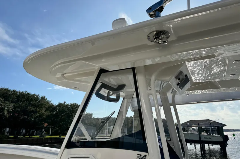  Yacht Photos Pics 2022 Regulator 34 boat with sleek design, docked under clear blue sky.