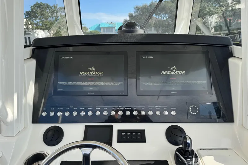  Yacht Photos Pics 2022 Regulator 34 boat dashboard with dual Garmin displays and control panel.