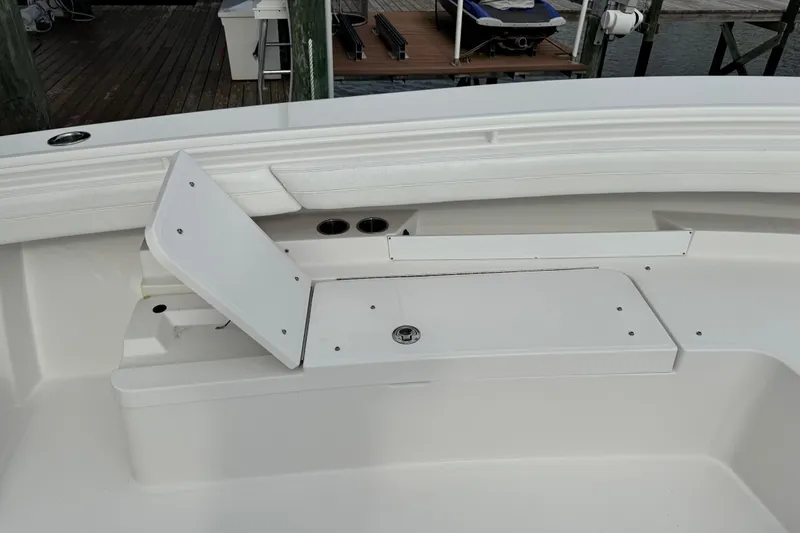  Yacht Photos Pics 2022 Regulator 34 boat interior with open storage compartment and cup holders.