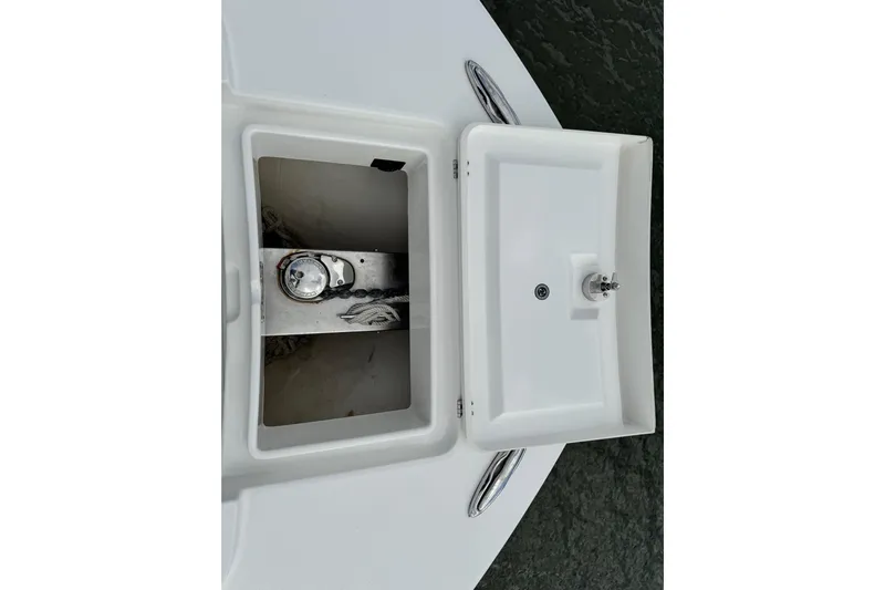  Yacht Photos Pics 2022 Regulator 34 boat anchor compartment with open hatch and visible chain.