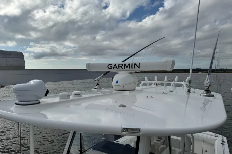  Yacht Photos Pics 2022 Regulator 34 boat with Garmin radar system on the roof, under cloudy sky.