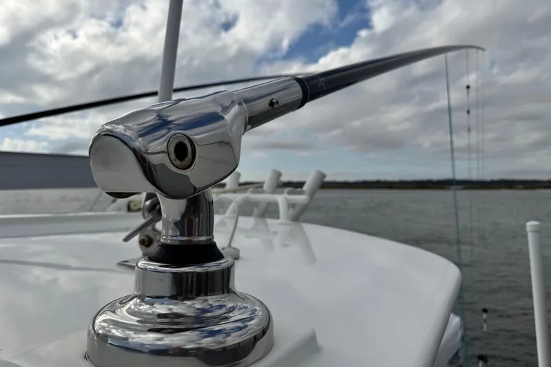  Yacht Photos Pics Close-up of a 2022 Regulator 34 boat's polished metal fitting against a cloudy sky.