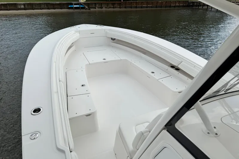  Yacht Photos Pics 2022 Regulator 34 boat interior with spacious seating and storage, docked by the water.