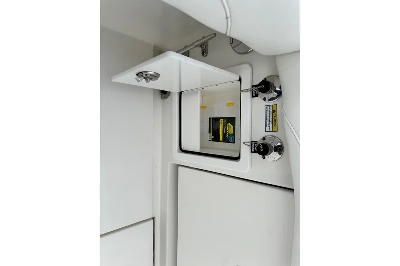  Yacht Photos Pics 2022 Regulator 34 boat compartment with open hatch and safety labels.