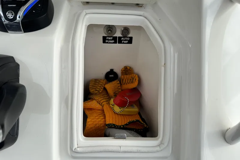  Yacht Photos Pics Storage compartment on 2022 Regulator 34 boat with pump controls and safety gear.