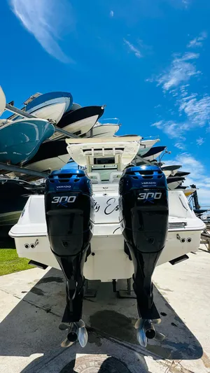  Yacht Photos Pics 2013 Boston Whaler 320 Outrage with twin 300 horsepower engines, docked under a clear blue sky.