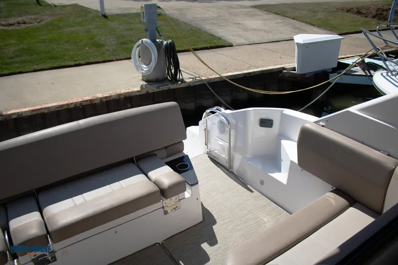 Knot On Call Yacht Photos Pics 2016 Regal 42 Sport Coupe boat interior with beige seating at dock.