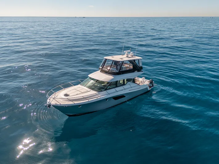 True North Yacht Photos Pics 2017 Tiara Yachts F53 Flybridge cruising on open blue sea.