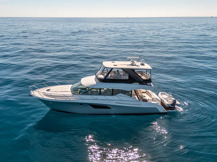 True North Yacht Photos Pics 2017 Tiara Yachts F53 Flybridge cruising on open sea under clear skies.