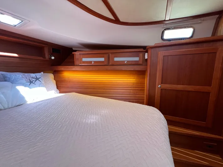 Family Affair Ix Yacht Photos Pics Luxurious cabin interior of 2018 Sabre 45 Salon Express yacht with wood paneling and cozy bedding.