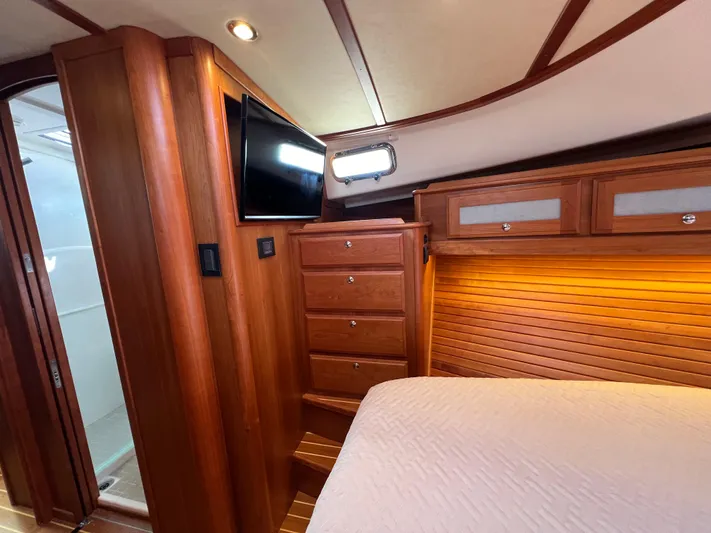 Family Affair Ix Yacht Photos Pics 2018 Sabre 45 Salon Express cabin with wood paneling, TV, and storage drawers.