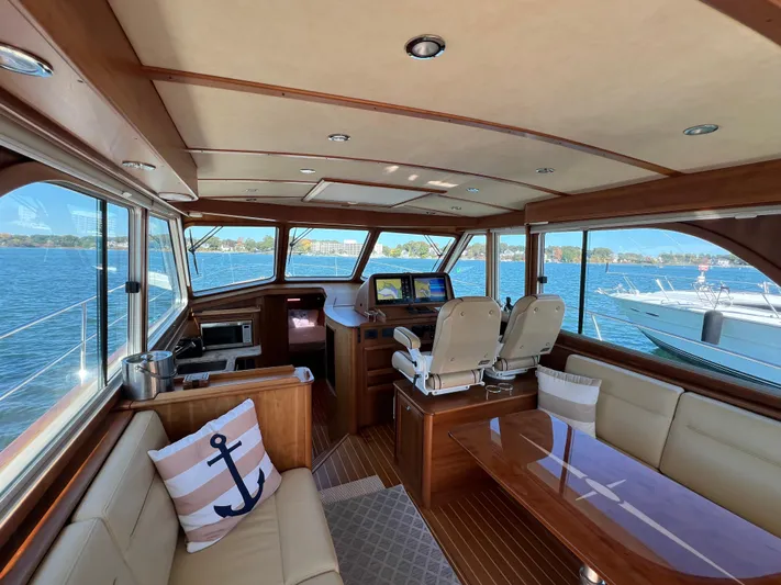 Family Affair Ix Yacht Photos Pics Luxurious 2018 Sabre 45 Salon Express yacht interior with panoramic windows and elegant seating.