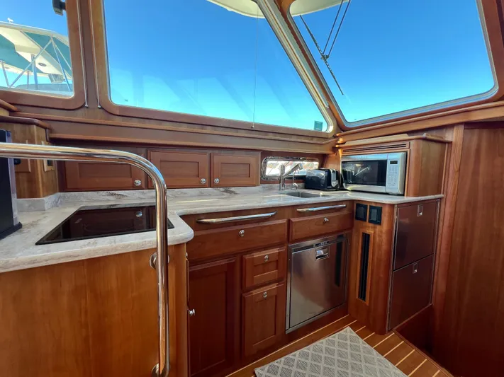 Family Affair Ix Yacht Photos Pics 2018 Sabre 45 Salon Express yacht kitchen with wood cabinetry and modern appliances.