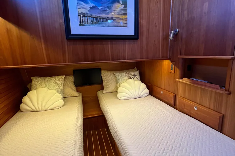Family Affair Ix Yacht Photos Pics Twin beds in 2018 Sabre 45 Salon Express cabin with wood paneling and decorative pillows.