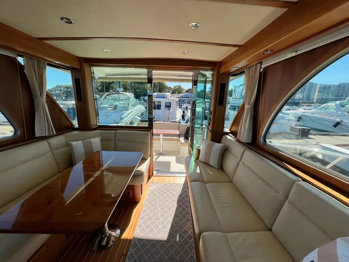 Family Affair Ix Yacht Photos Pics Interior of 2018 Sabre 45 Salon Express yacht with elegant seating and wooden table.